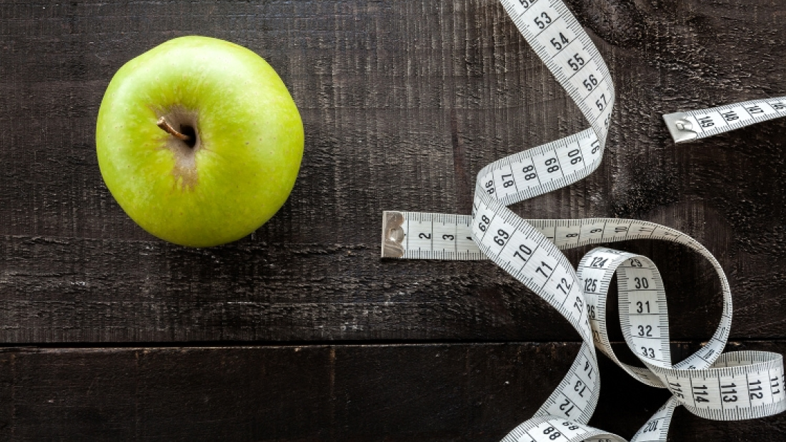 photo of an apple and roll of measuring tape