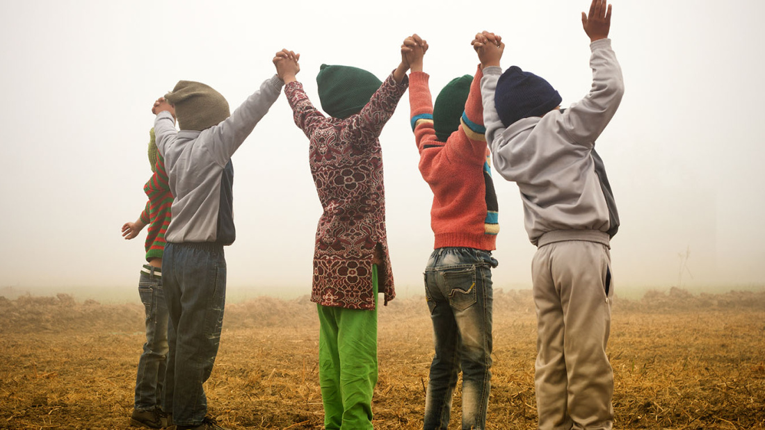 Children standing holding hands