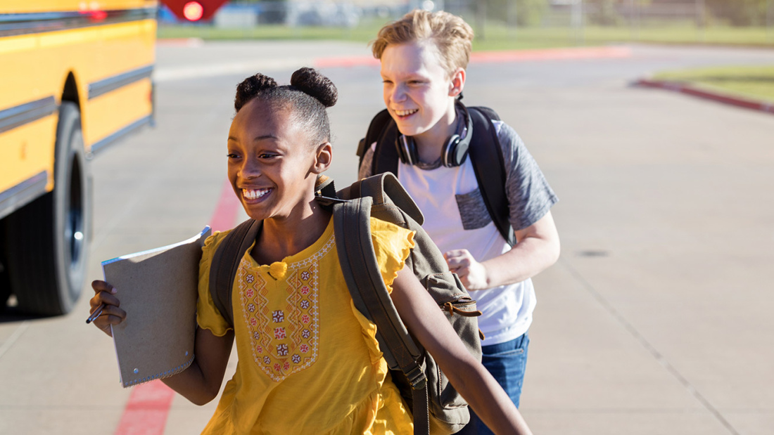 Kids smiling on school bus