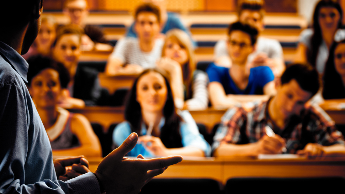 Lecturer stands in front of a college seminar