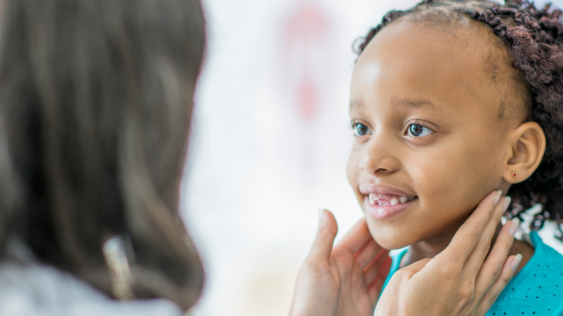 doctor checking a child's lymph nodes