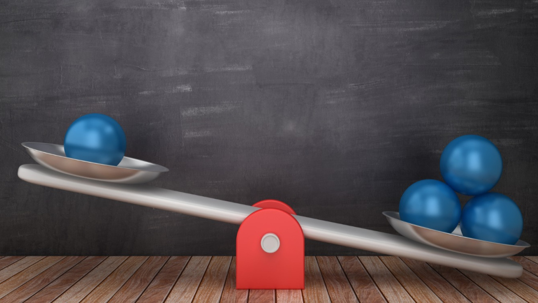seesaw scale with uneven weights, suggesting unfair advantage