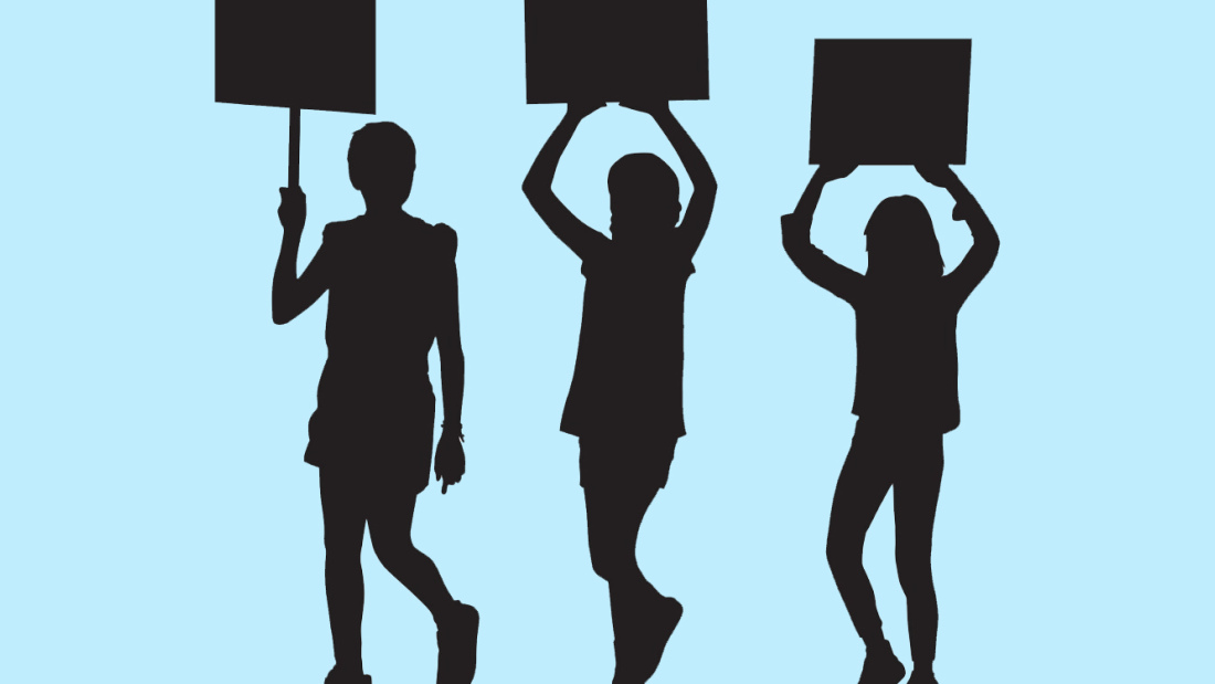 silhouettes of three young teen students holding signs 