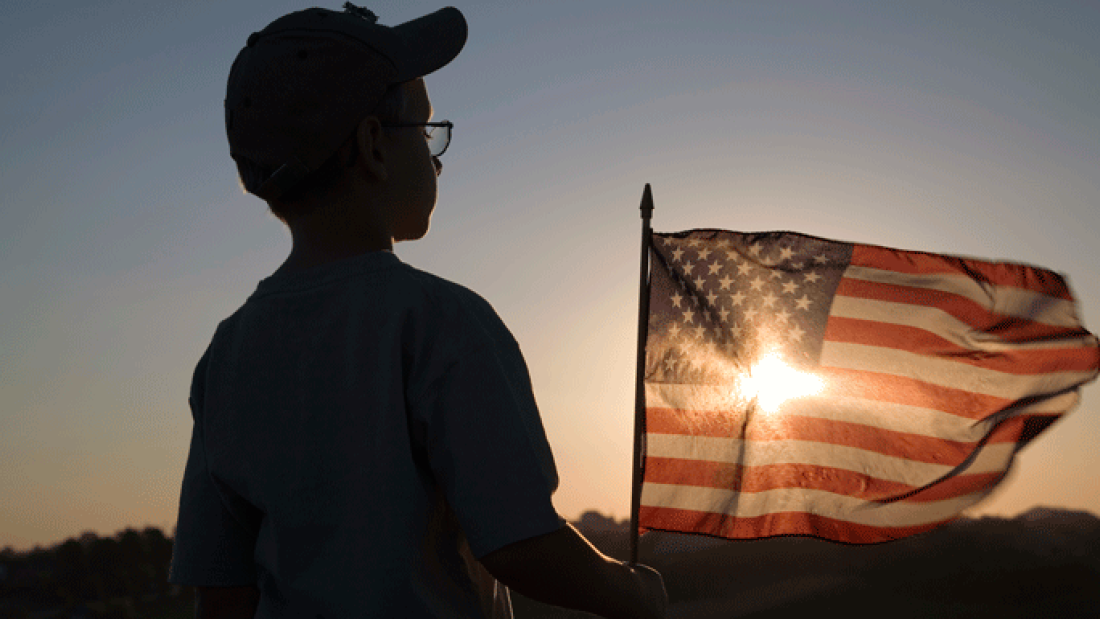 Boy holding American flag