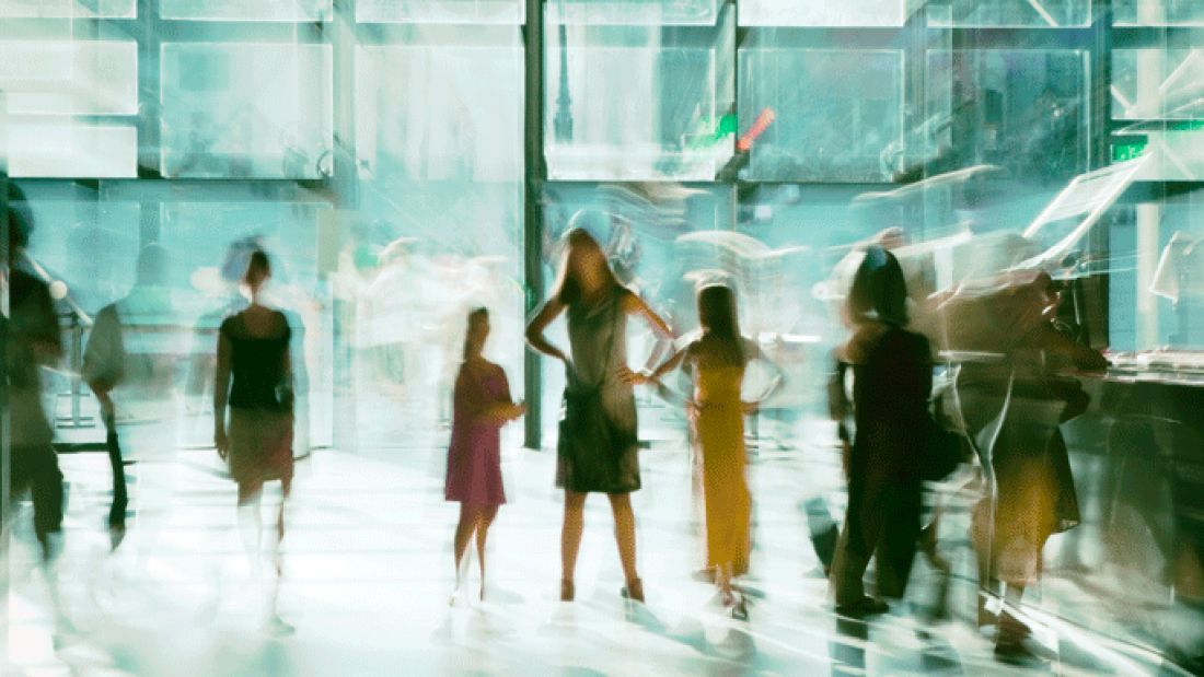 A blurry photograph of adults and children inside a museum