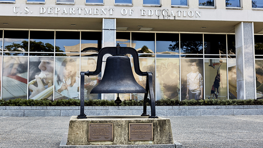 US Department of Education exterior, with old school bell in front