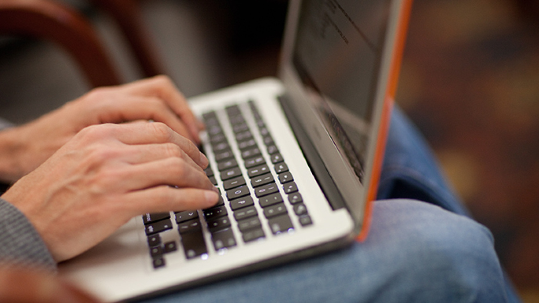 Close-up of hands over a laptop keyboard