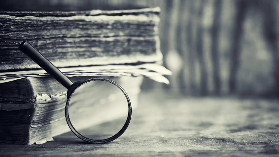 Magnifying glass and books