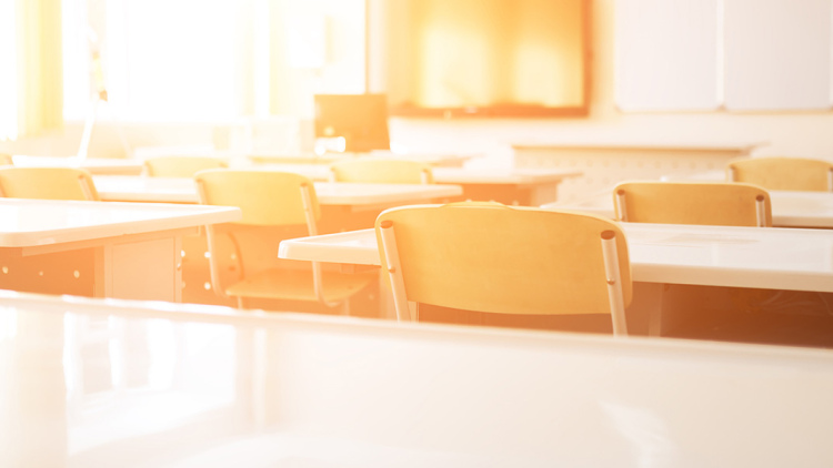 Empty classroom with sun shining in 