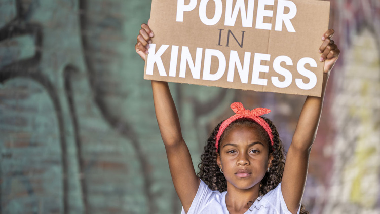 Child with sign - Power is Kindness