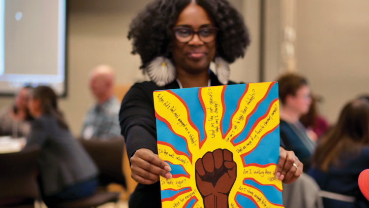 A black woman presents art with a brown-skinned fist surrounded by key questions about education and motivation