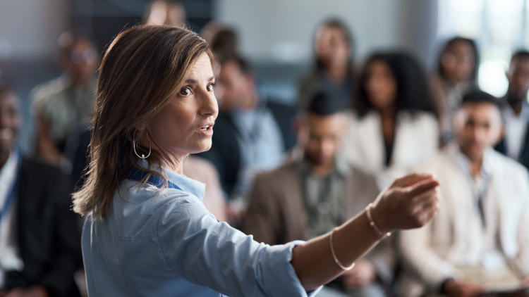 Woman delivers a presentation at a conference.