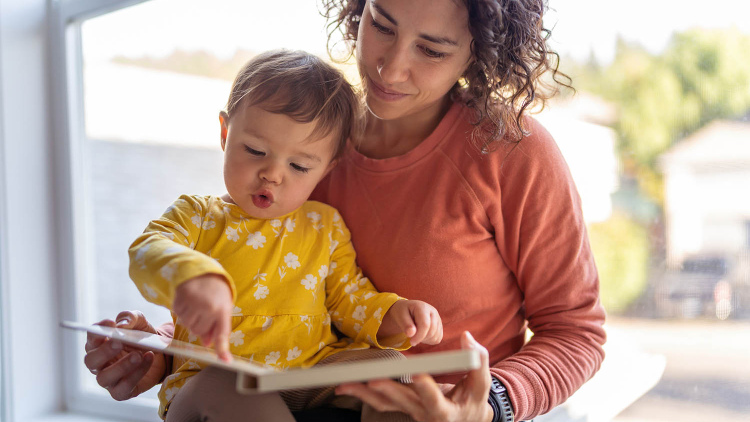 Mother reading with baby