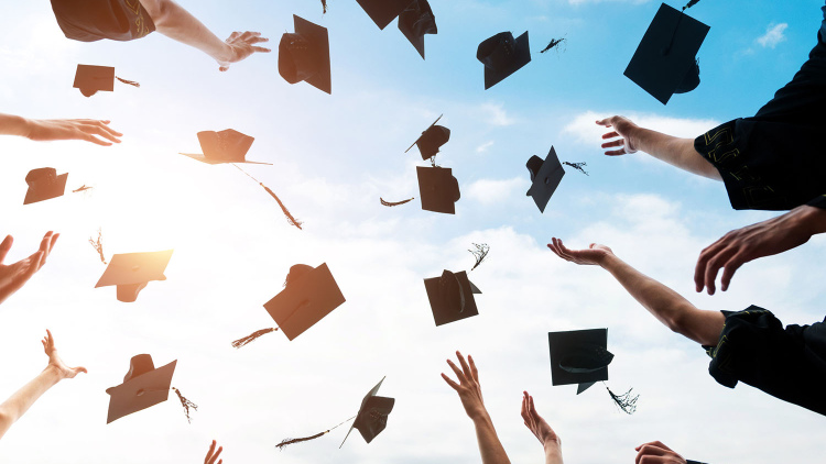 Graduation caps being tossed