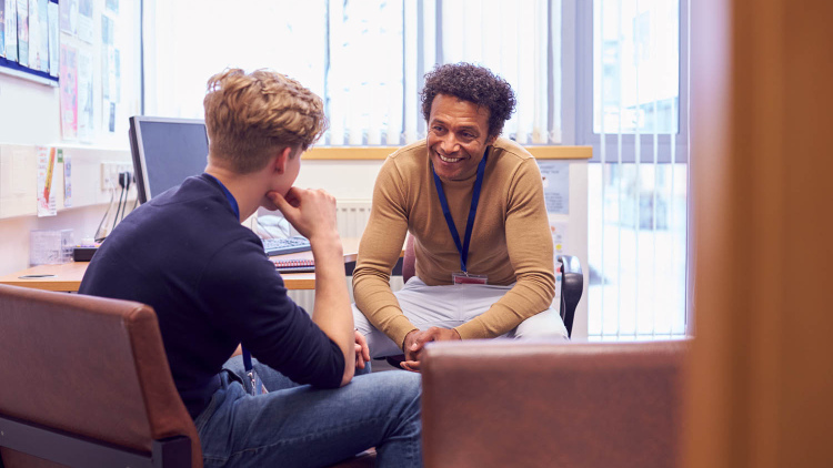 School counselor with student in office