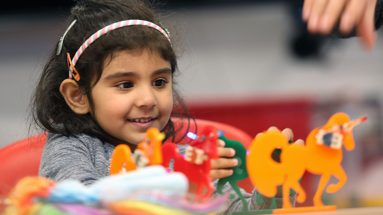 Rahimeen Jazib, 3, sees the toy created for her by her father, master's candidate Jazib Zahir