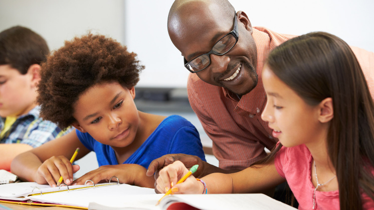 Teacher helping students
