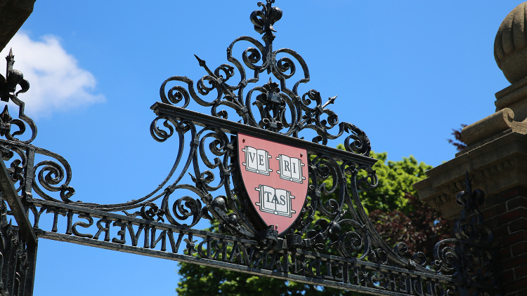 Harvard Yard gates with Veritas logo