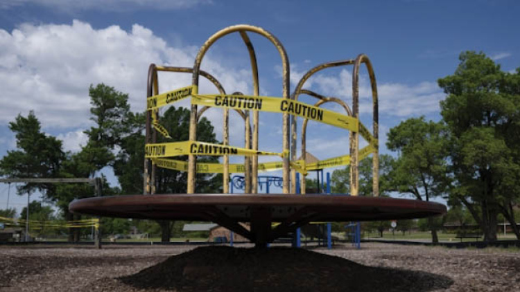 Playground merry go round with caution tape