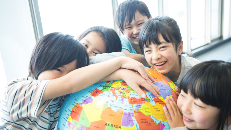 Children playing with globe