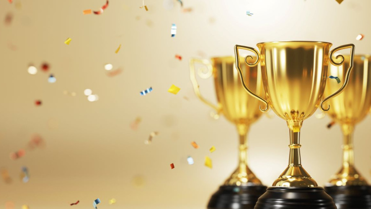 Gold trophies with confetti falling