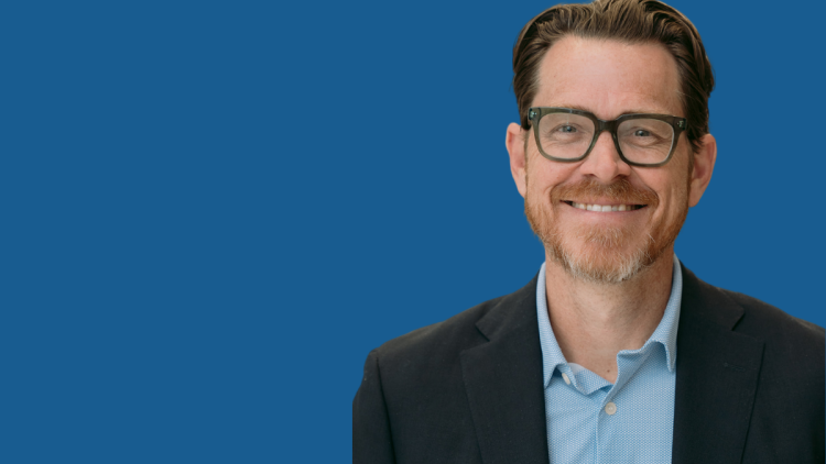 Photo of Tyler Thigpen on a blue backdrop