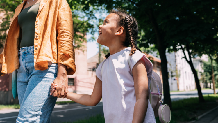 Girl holding hands with her mom
