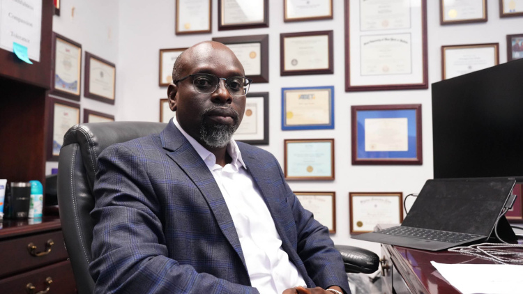 Dr. Mebougna Drabo sits at his desk in his office at Alabama A&M University