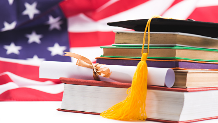 Graduation hat with the American flag in the background