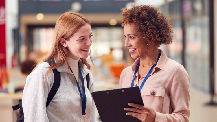 Two women meeting in school building
