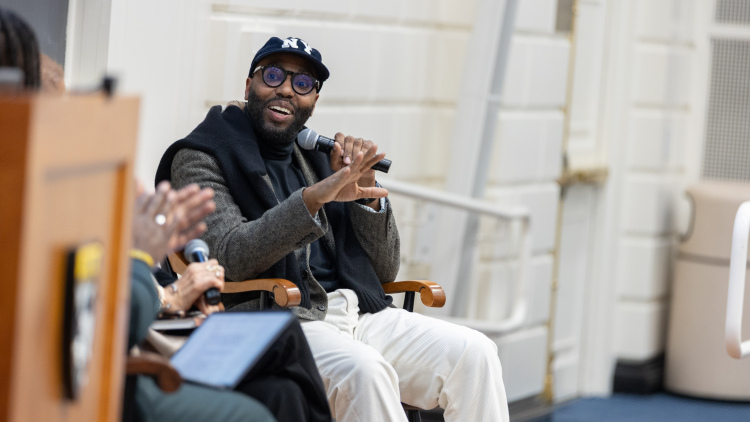 Teachers College at Columbia University professor Chris Emdin addresses Askwith Hall during Friday evening's keynote address.