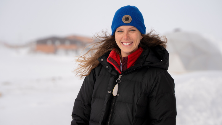 Michelle-Anne_Engelstad stands outside in the Arctic, surrounded by snow
