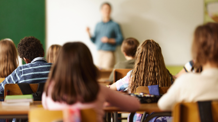 Middle school students sitting at their desks