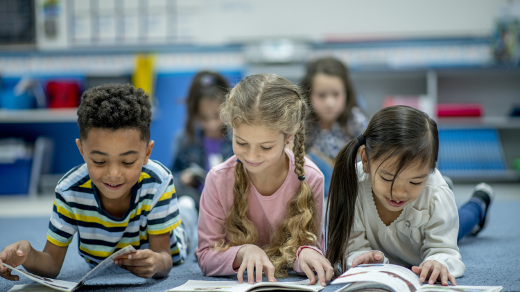 three elementary school students reading
