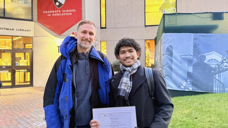 John Ramos receives his certificate outside HGSE's Gutman Library