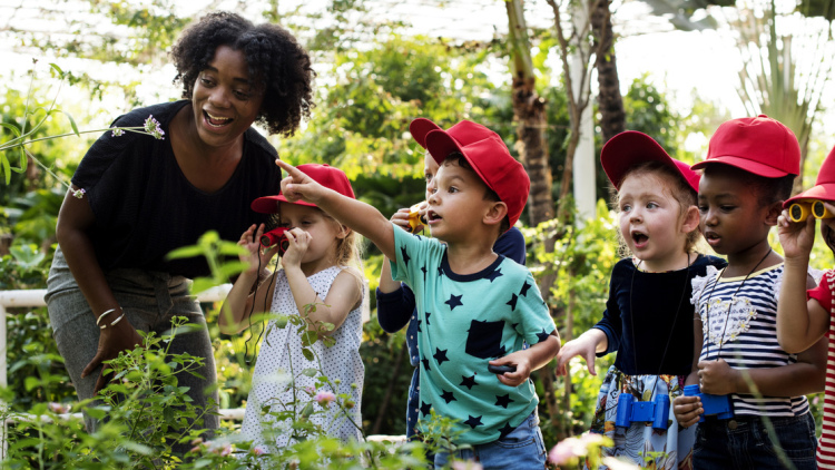 Children with teacher in a greenhouse
