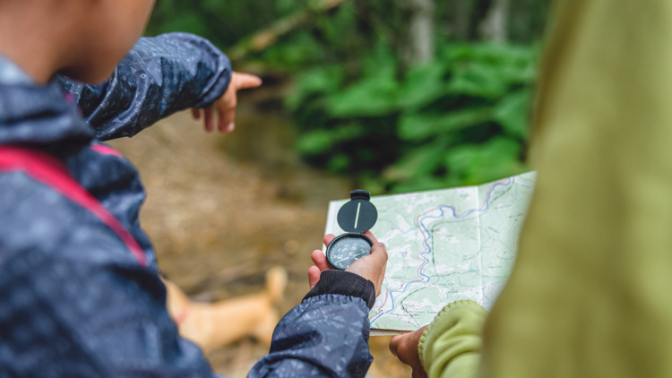 Family hiking with compass