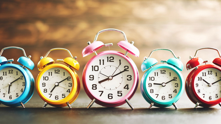 Line of alarm clocks telling different times
