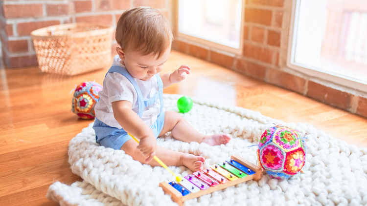 Baby playing musical instrument