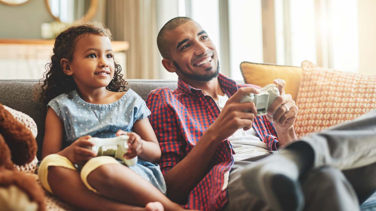 Father and daughter playing video games