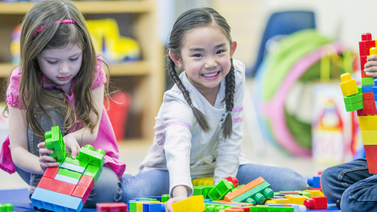 Girl playing with lego at school