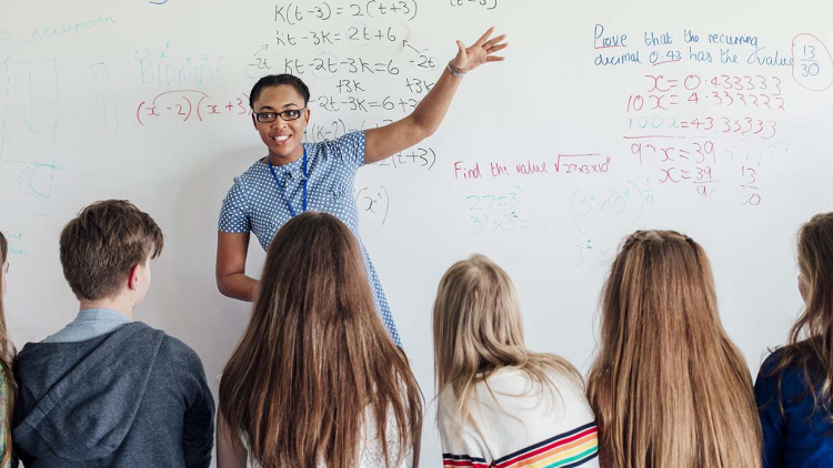 Math teacher in front of white board
