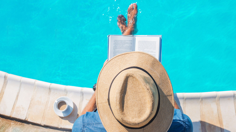 Man reading by the pool
