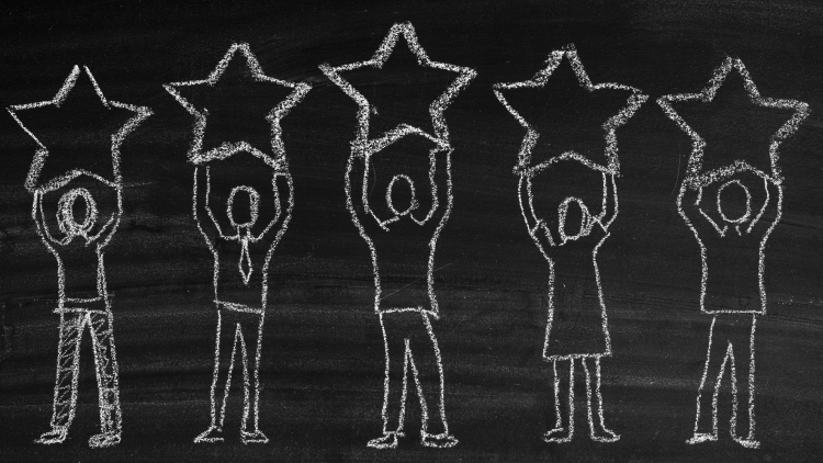 Chalkboard drawing of people holding stars