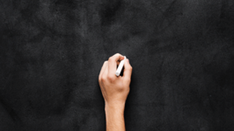 photo of a hand on a blackboard