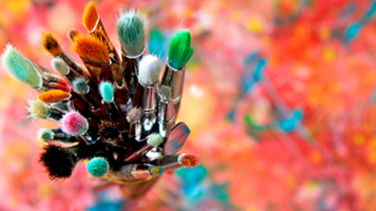 paint brushes against colorful background