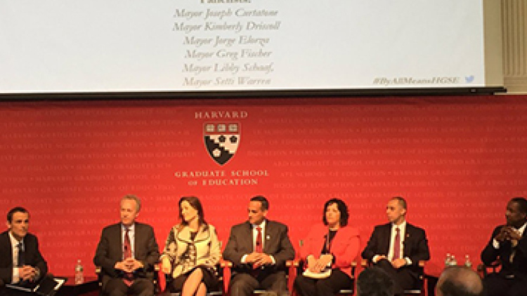 Six city mayors shown on stage at the Harvard Graduate School of Education
