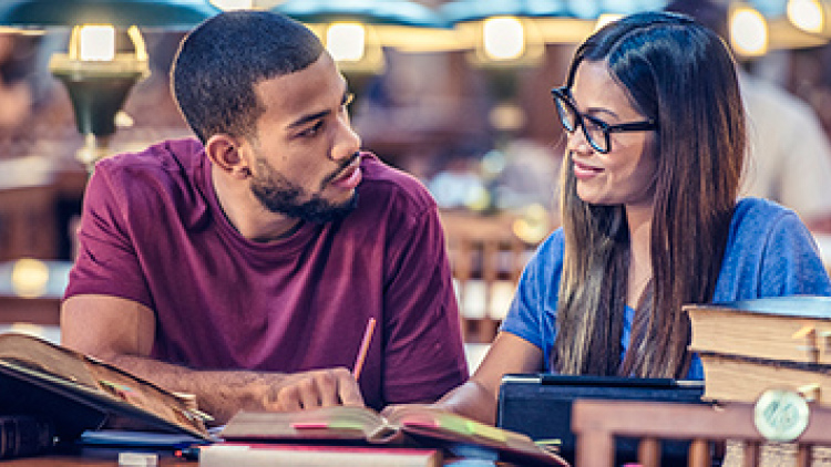 Male and female college student studying in library