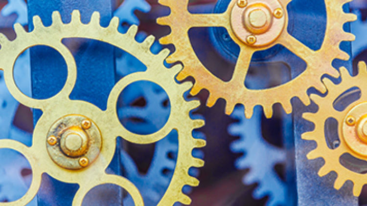 Gold-colored gears turning against a blue background various sizes
