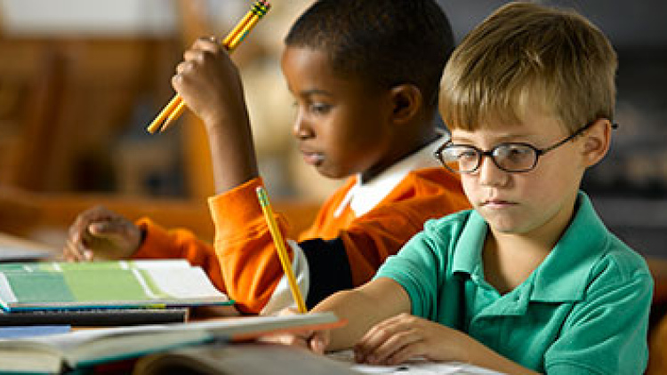 Two boys doing school work